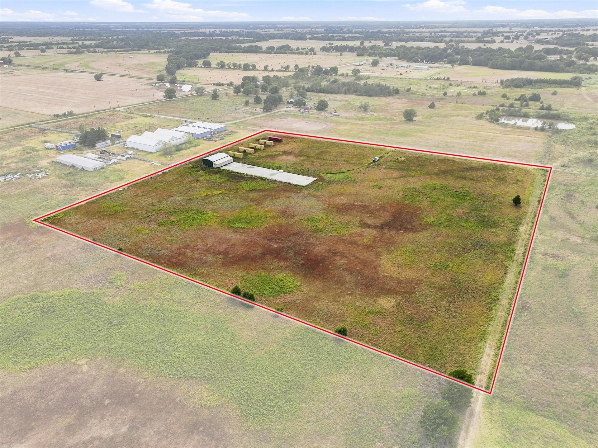180 Tower Road Bokchito, OK 74726 - Photo 17 of 49 Expansive undeveloped land featuring a red-lined property boundary and several permanent outbuildings
