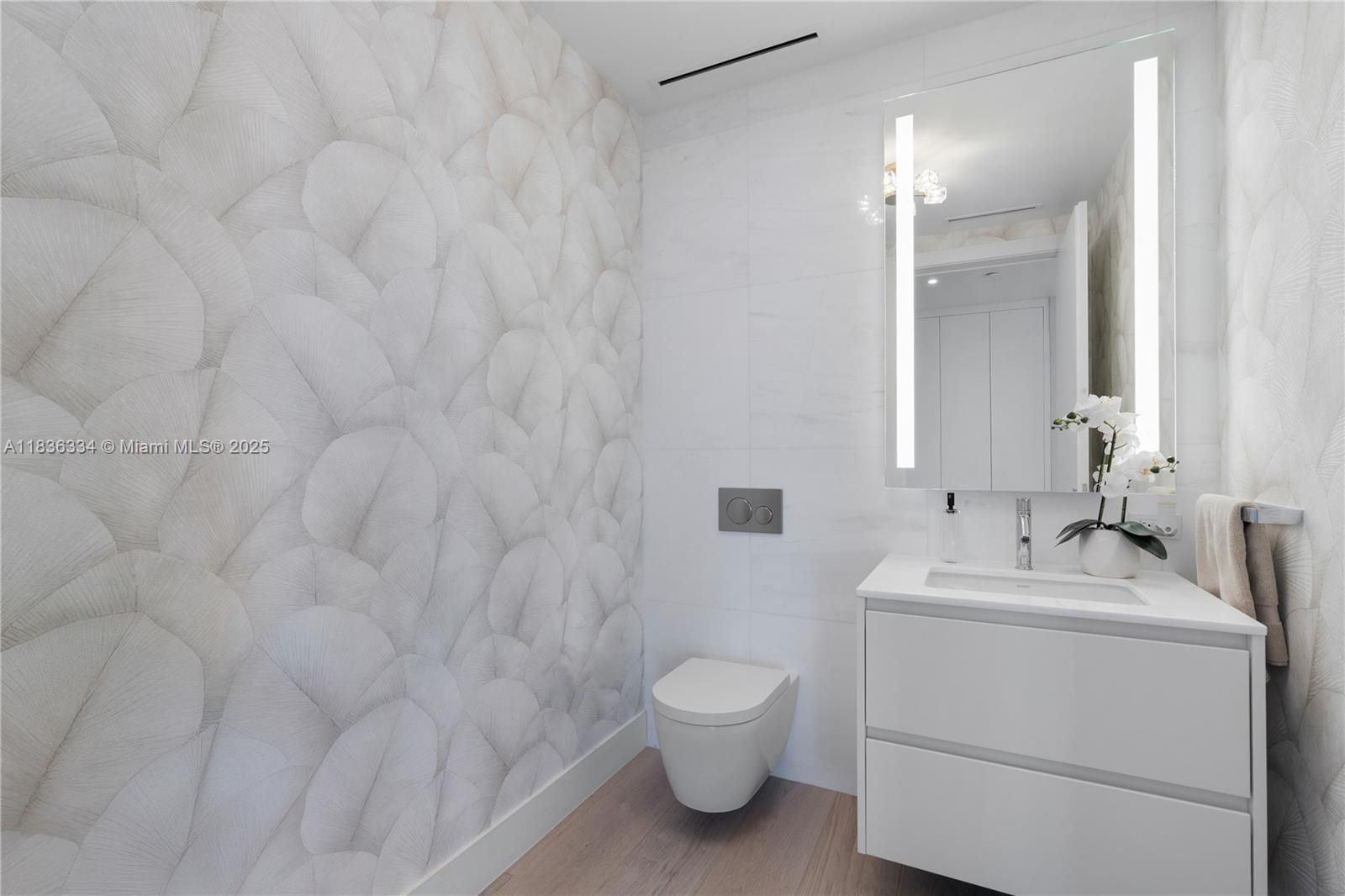 300 Biscayne Blvd Way, Unit 4707 Miami, FL 33131 - Photo 15 of 21 a bathroom with a toilet sink vanity and mirror