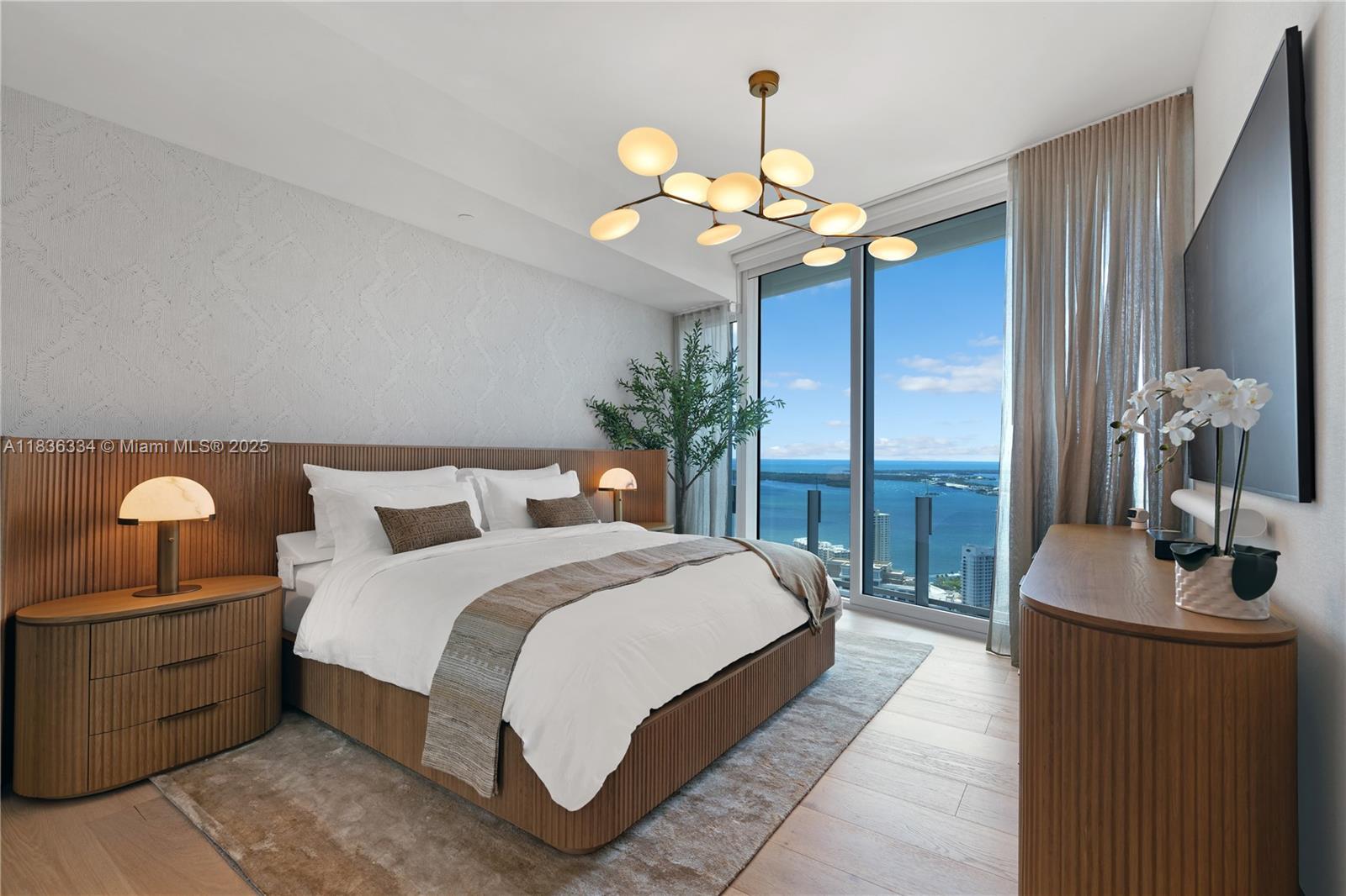 300 Biscayne Blvd Way, Unit 4707 Miami, FL 33131 - Photo 16 of 21 a bedroom with a bed chandelier and a window