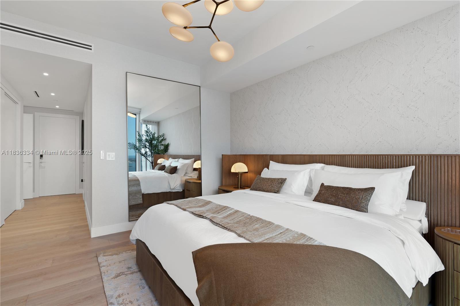 300 Biscayne Blvd Way, Unit 4707 Miami, FL 33131 - Photo 17 of 21 a bedroom with a bed and a chandelier