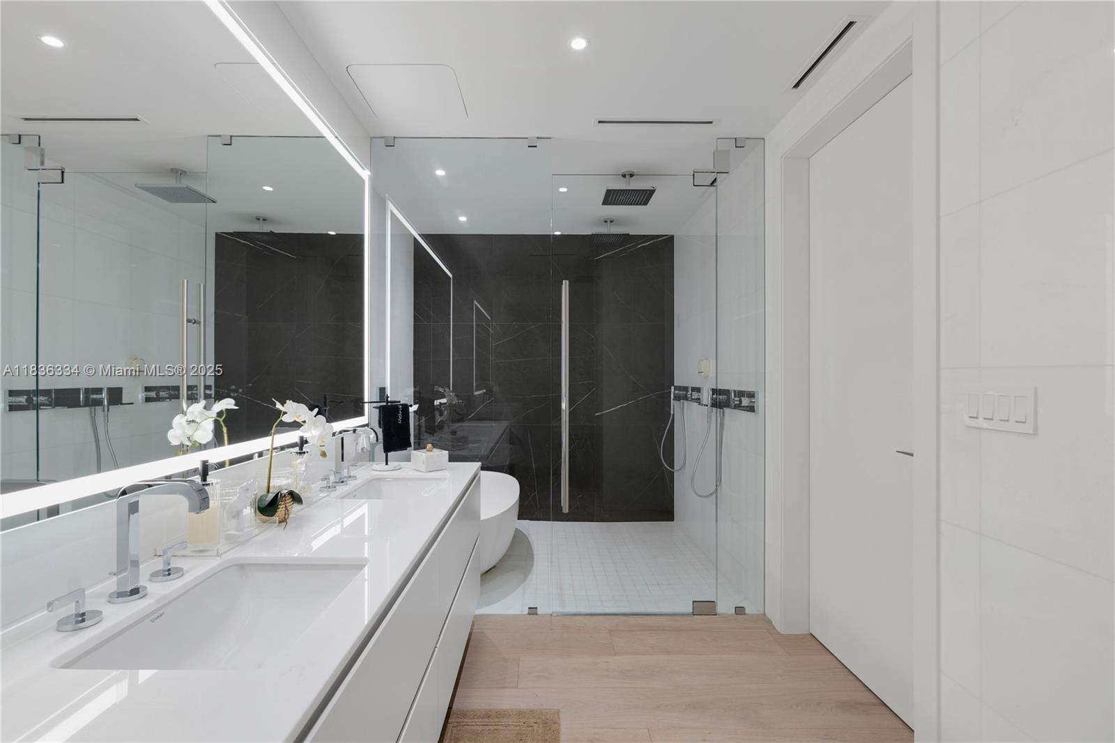 300 Biscayne Blvd Way, Unit 4707 Miami, FL 33131 - Photo 19 of 21 a bathroom with a double vanity sink a mirror and shower