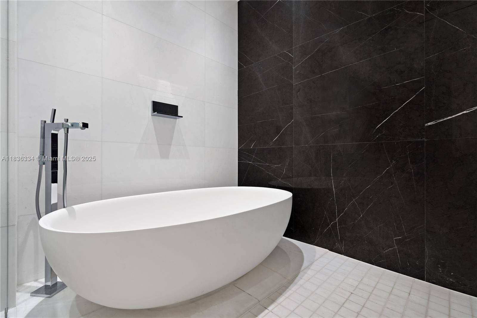 300 Biscayne Blvd Way, Unit 4707 Miami, FL 33131 - Photo 4 of 21 a white bath tub sitting in a bathroom