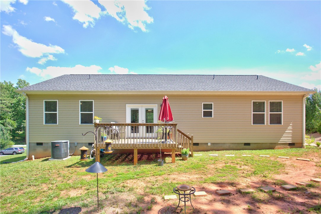 405 Pawnee Drive Walhalla, SC 29691 - Photo 25 of 36 A welcoming wooden deck extends from this comfortable residence, offering a serene outdoor retreat.