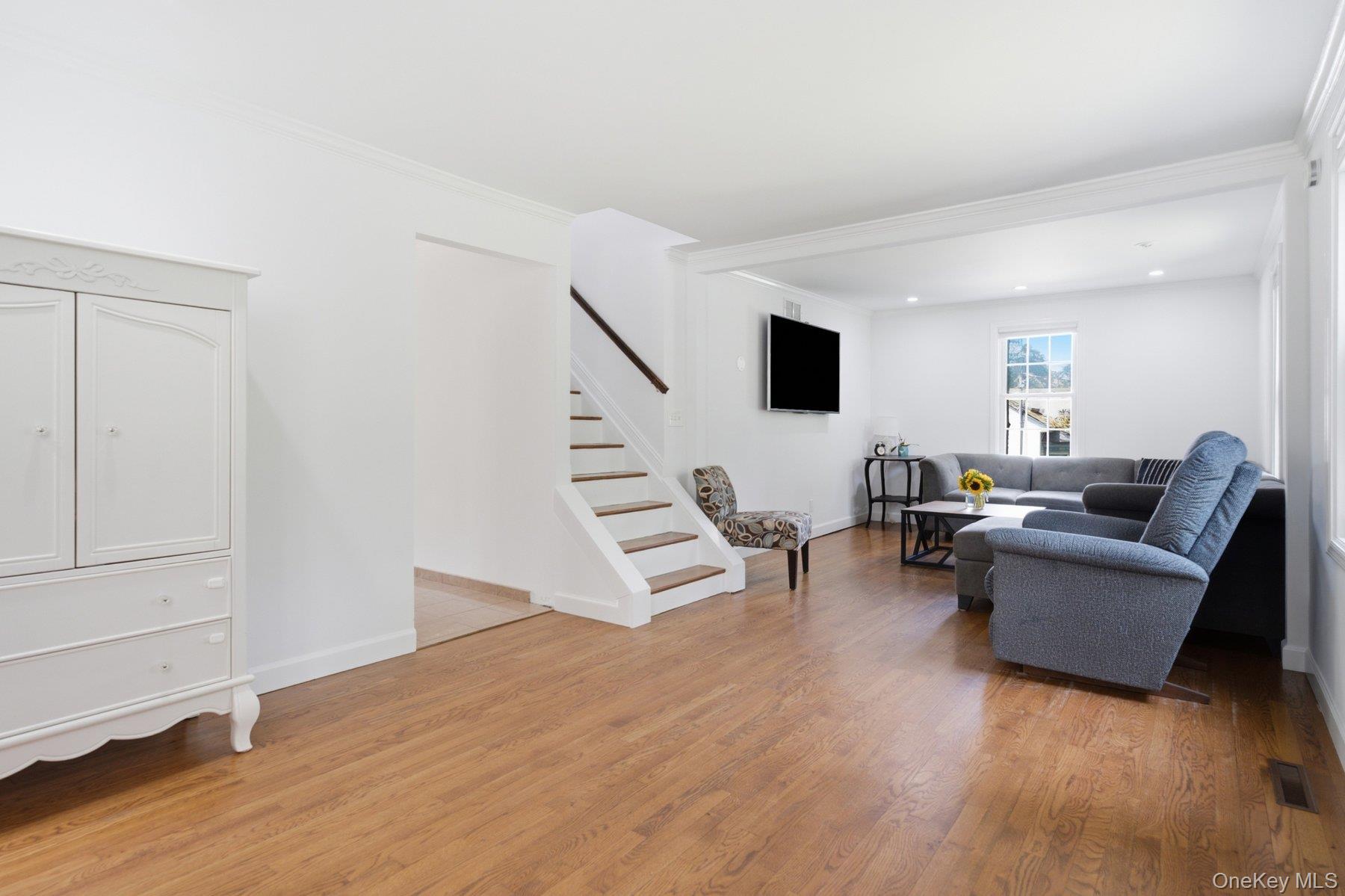 81 Beach Road Wading River, NY 11792 - Photo 3 of 25 a living room with furniture and a wooden floor