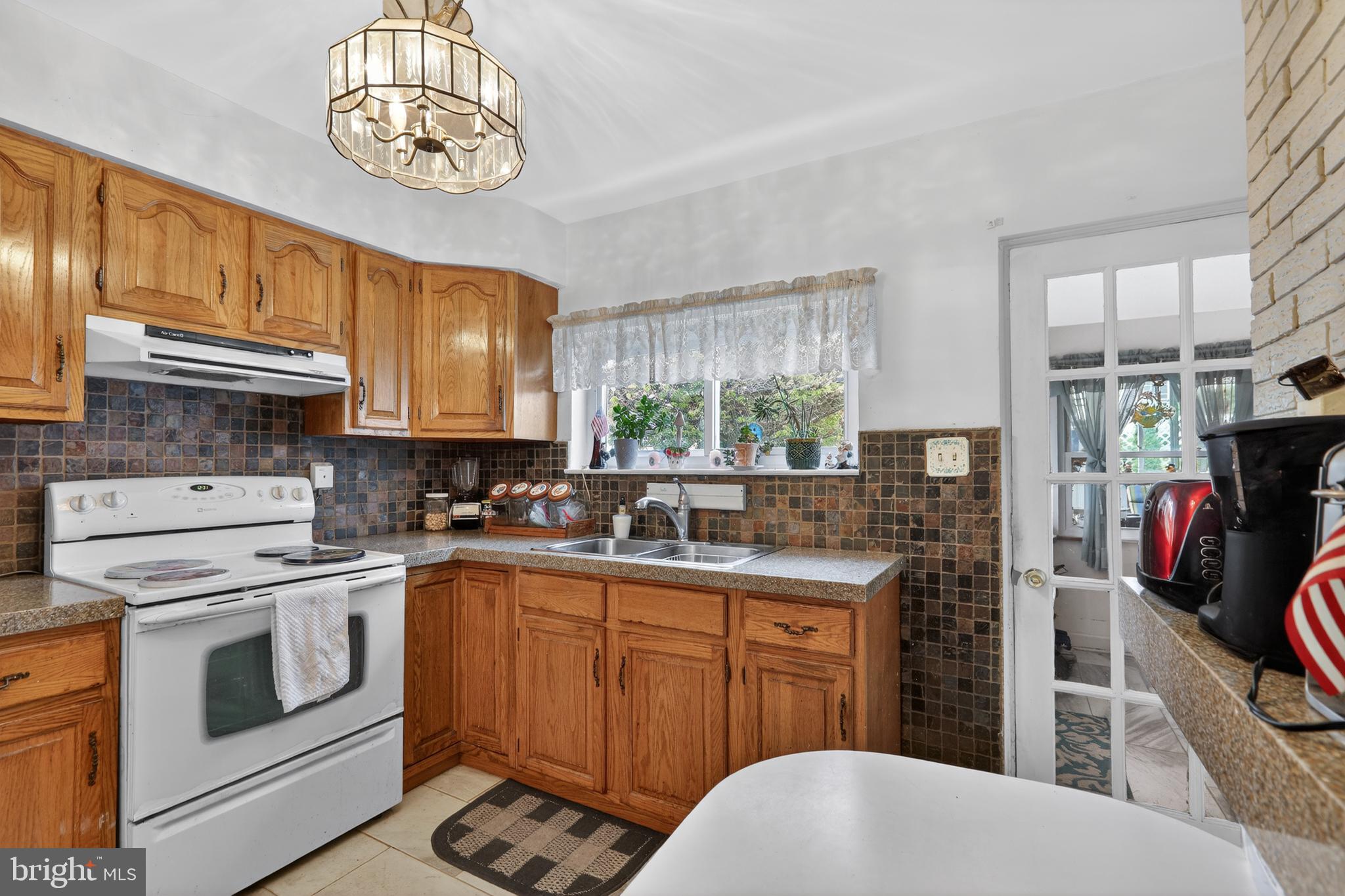 1424 Burmont Road Havertown, PA 19083 - Photo 13 of 37 a kitchen with a stove a sink and cabinets