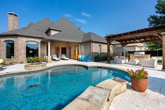 a view of a house with swimming pool and sitting area