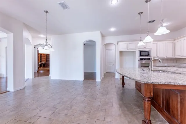 a kitchen with stainless steel appliances granite countertop a stove and a sink