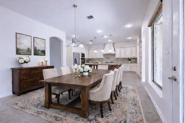 a view of a kitchen center island and stainless steel appliances