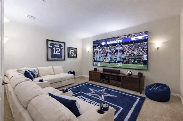 a living room with furniture a rug and a flat screen tv