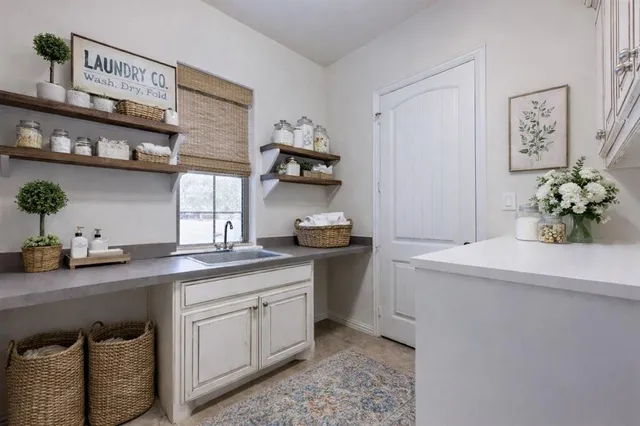 a kitchen with stainless steel appliances granite countertop a sink a stove and cabinets