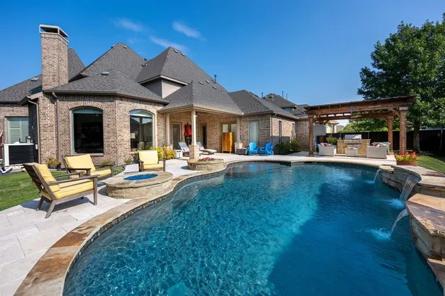 a view of a house with patio and a yard