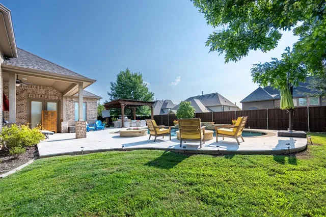a view of a house with backyard and sitting area