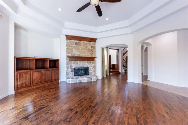 a living room with wooden floors and a fireplace
