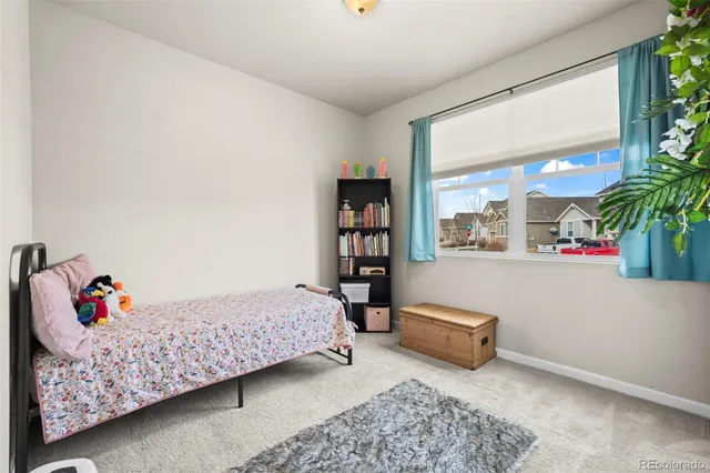 a bedroom with a bed and a couch