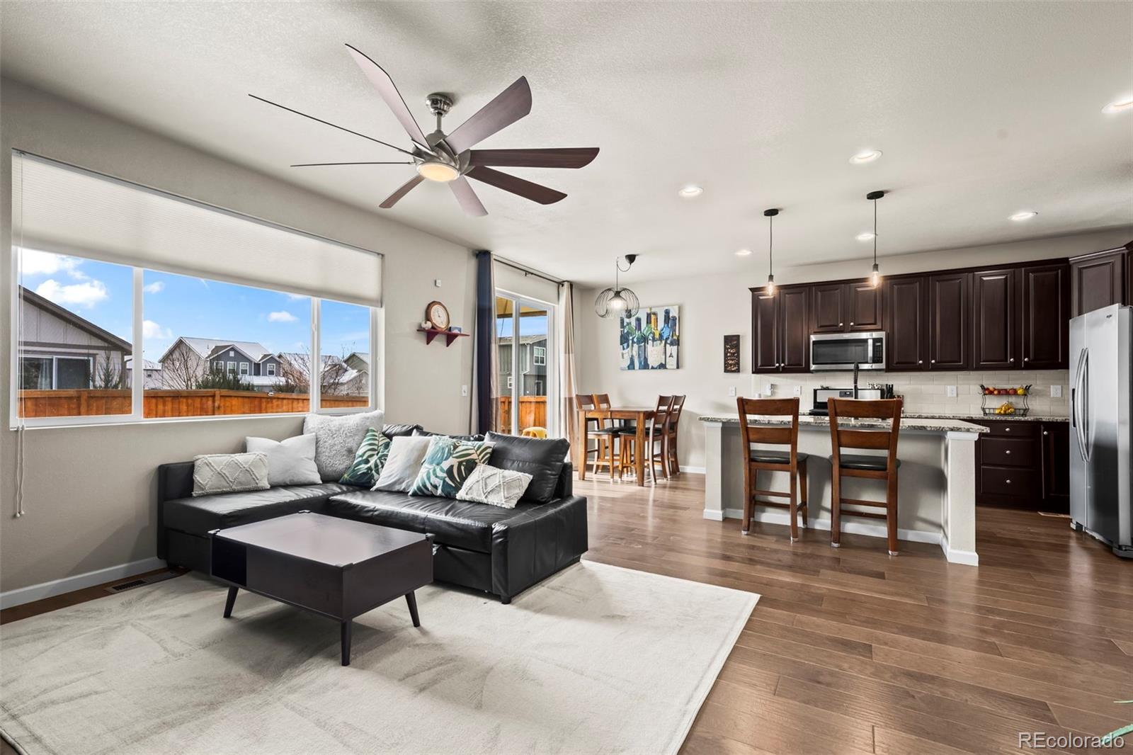 593 Country Road Berthoud, CO 80513 - Photo 4 of 34 a living room with furniture kitchen view and a wooden floor