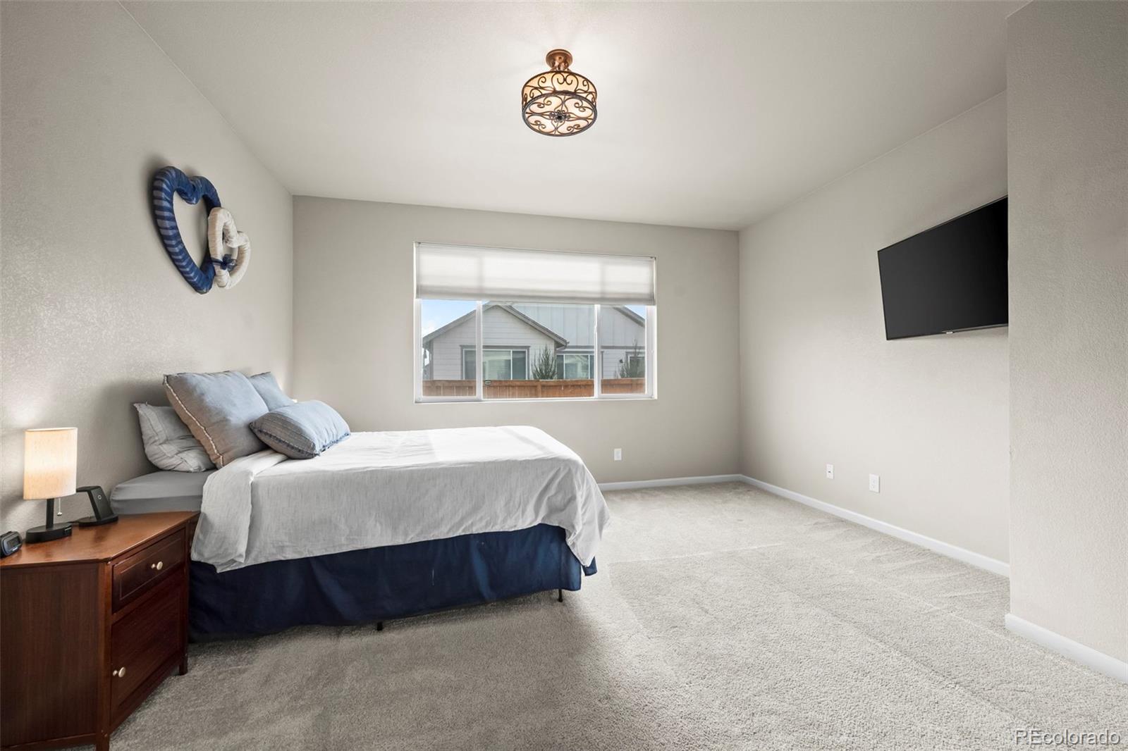 593 Country Road Berthoud, CO 80513 - Photo 9 of 34 a spacious bedroom with a bed and a window