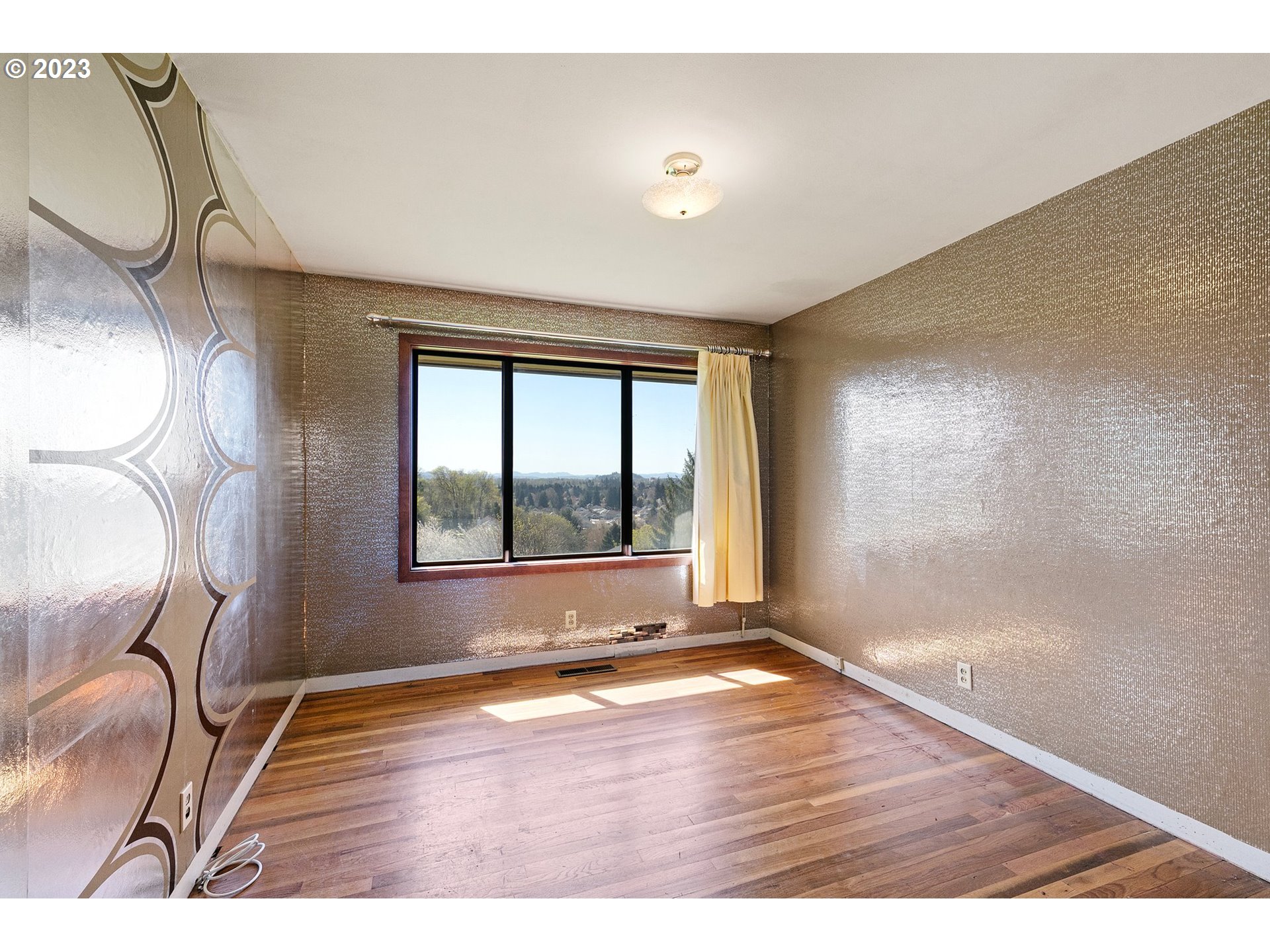 734 Summit Boulevard Springfield, OR 97477 - Photo 24 of 41 a view of an empty room with a window and wooden floor