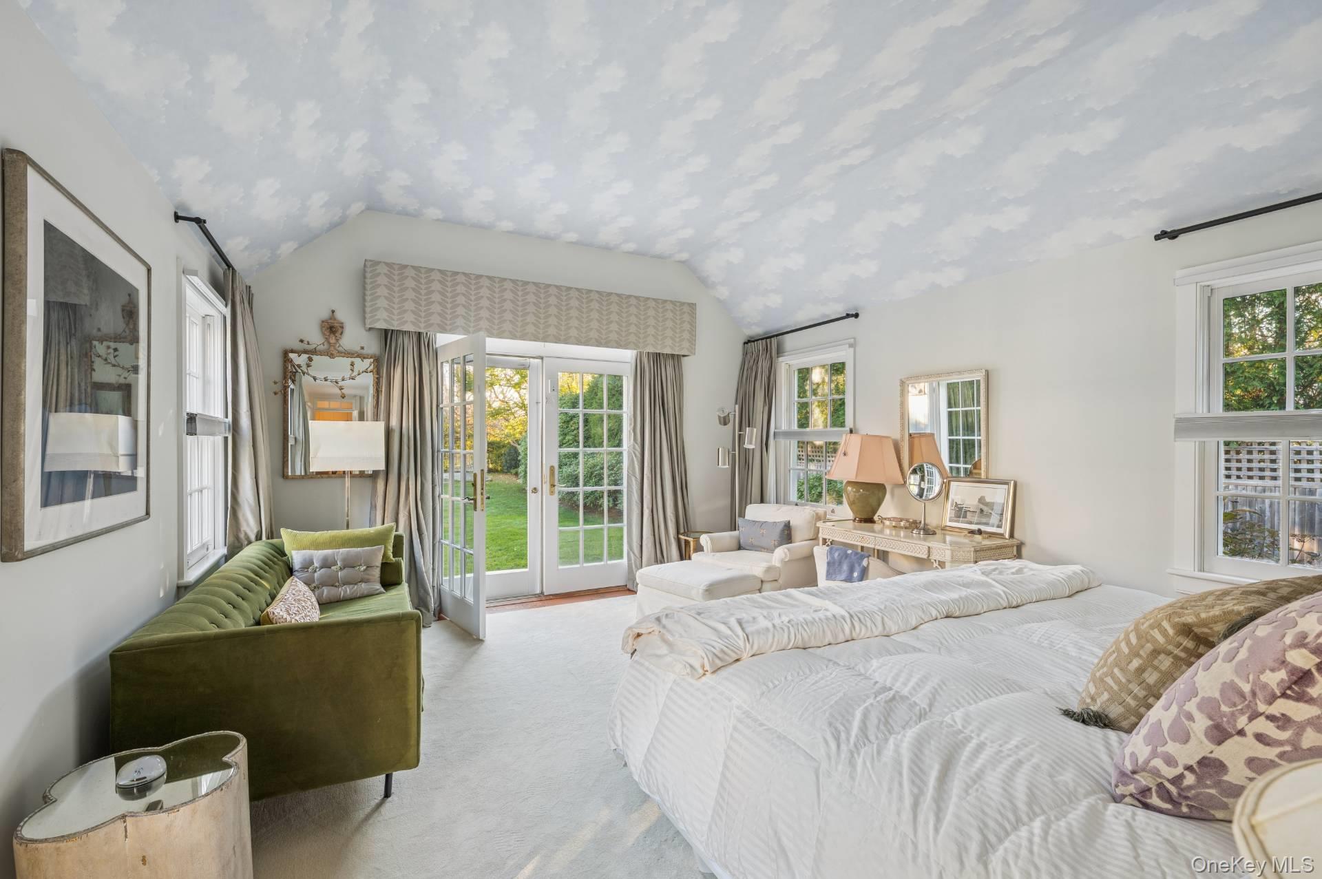 94 Post Lane Southampton, NY 11968 - Photo 11 of 34 a bedroom with a bed and glass windows