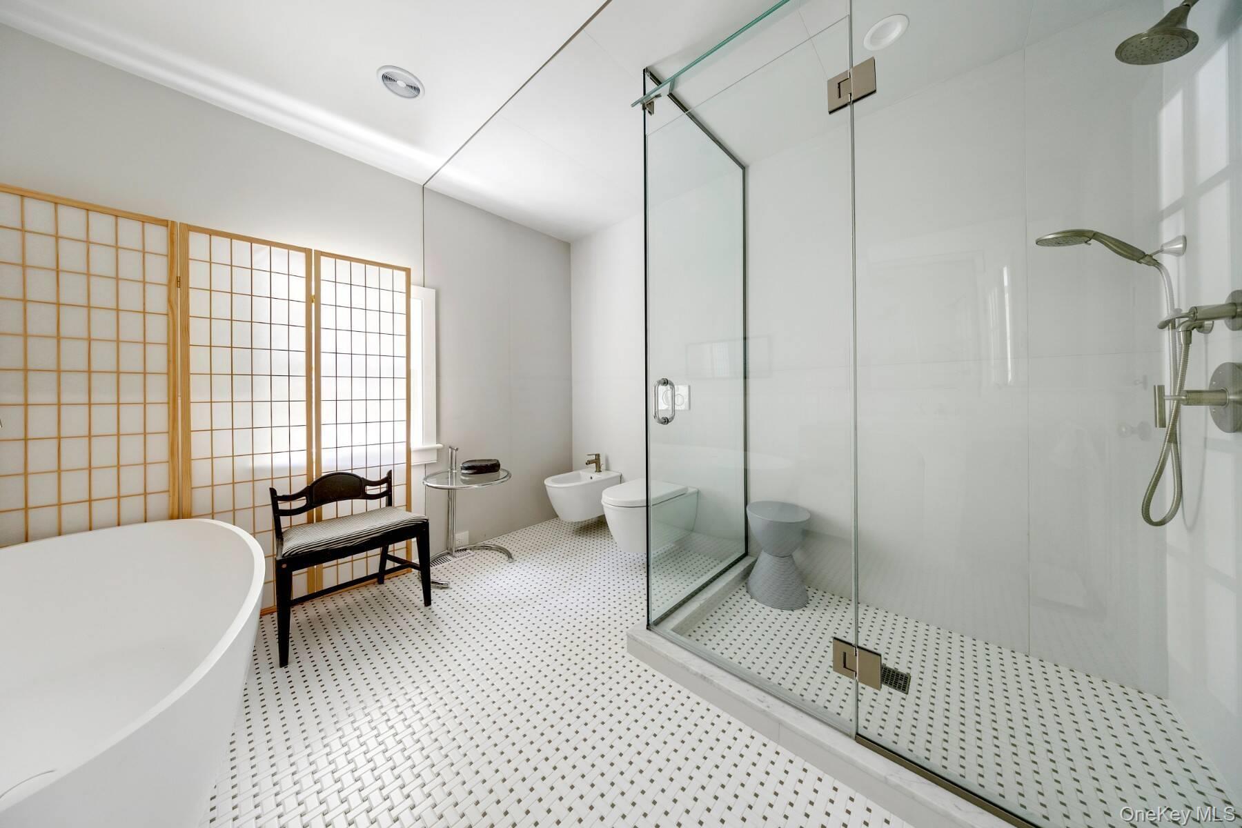 94 Post Lane Southampton, NY 11968 - Photo 13 of 34 a bathroom with a bathtub and a shower