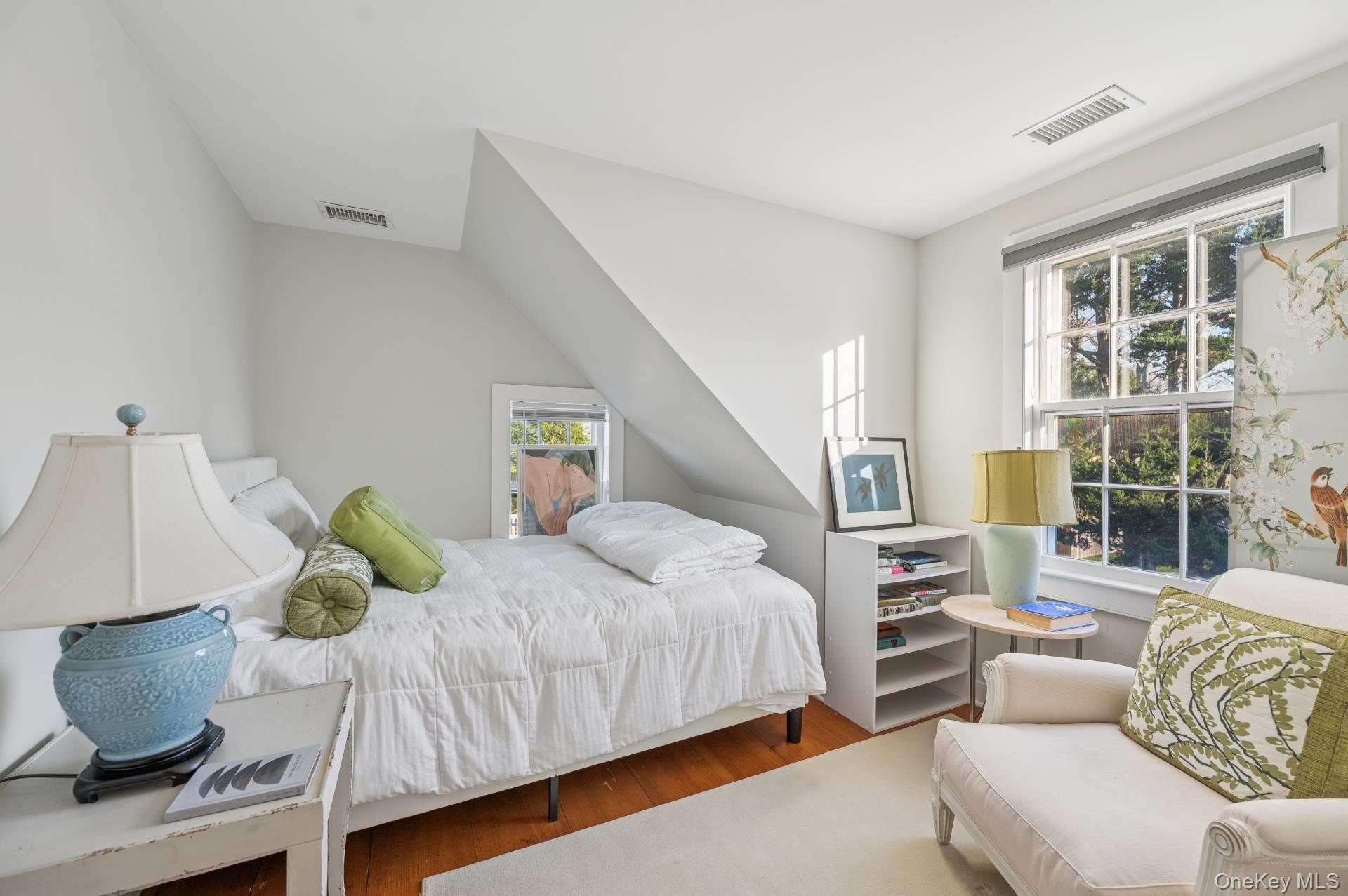 94 Post Lane Southampton, NY 11968 - Photo 15 of 34 a bedroom with a bed and wooden floor