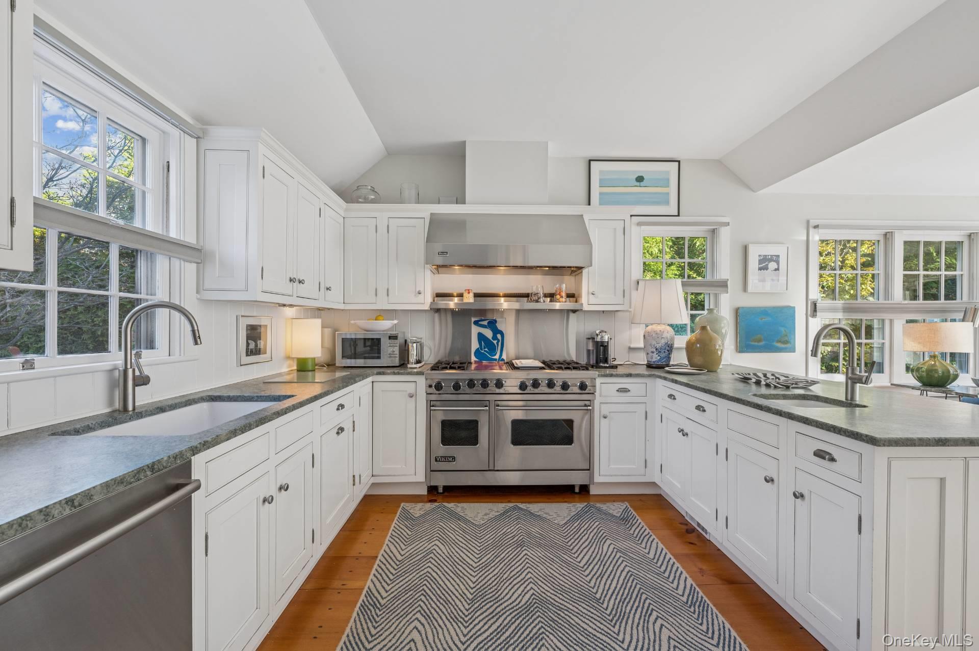 94 Post Lane Southampton, NY 11968 - Photo 19 of 34 a kitchen with stainless steel appliances granite countertop a stove sink and cabinets
