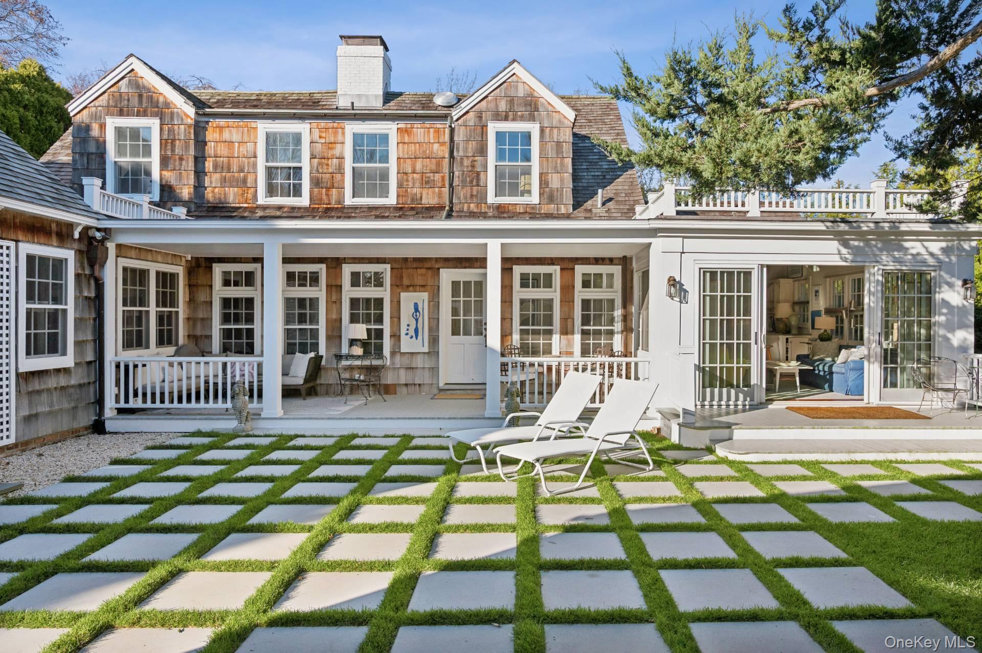 94 Post Lane Southampton, NY 11968 - Photo 23 of 34 a view of a house with a patio