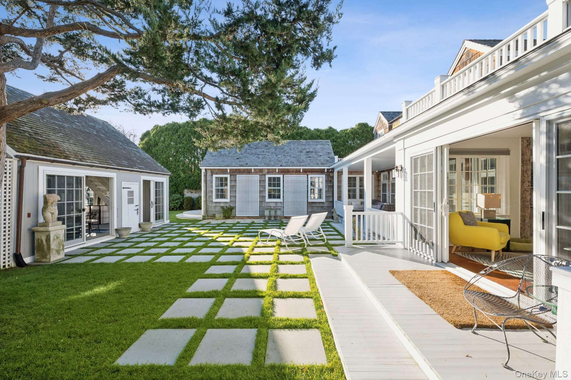 94 Post Lane Southampton, NY 11968 - Photo 24 of 34 a front view of house with yard patio and green space