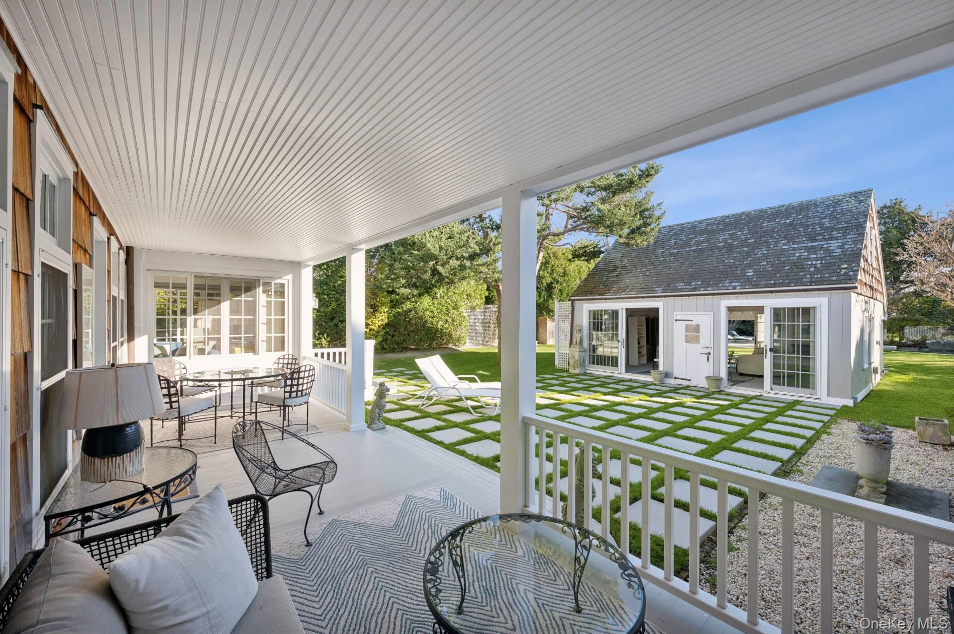 94 Post Lane Southampton, NY 11968 - Photo 25 of 34 a living room with furniture floor to ceiling window and wooden floor