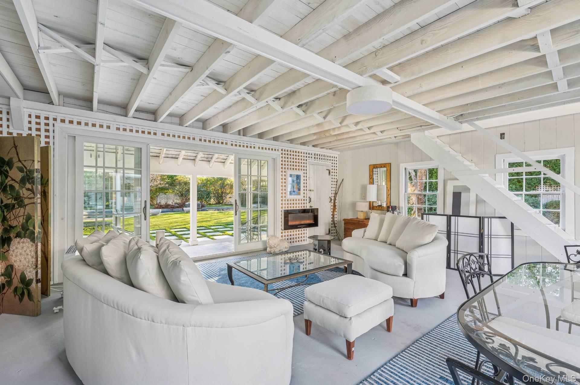 94 Post Lane Southampton, NY 11968 - Photo 29 of 34 a living room with furniture and a large window