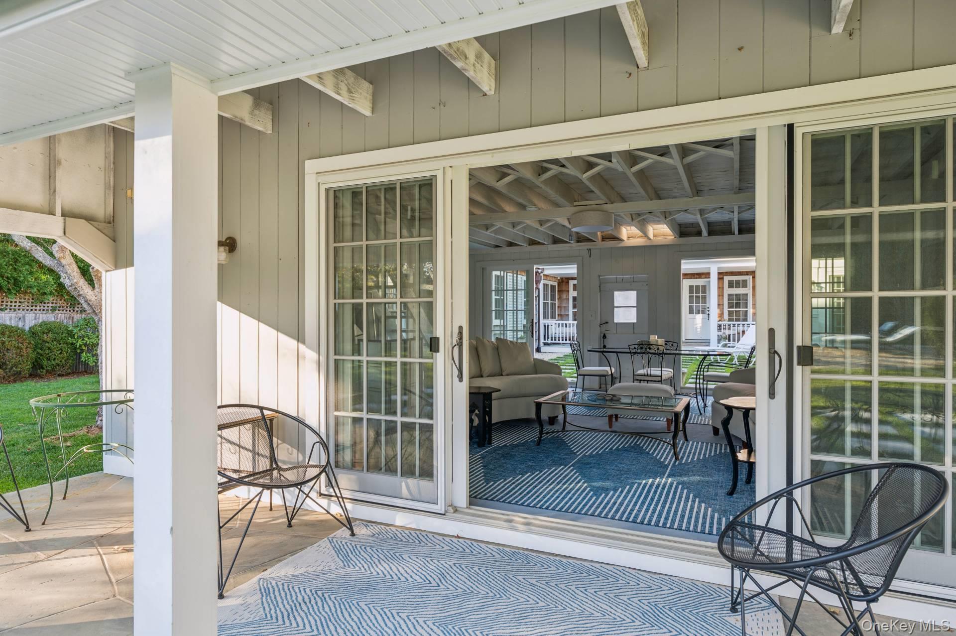 94 Post Lane Southampton, NY 11968 - Photo 30 of 34 a view of a patio with table and chairs and potted plants