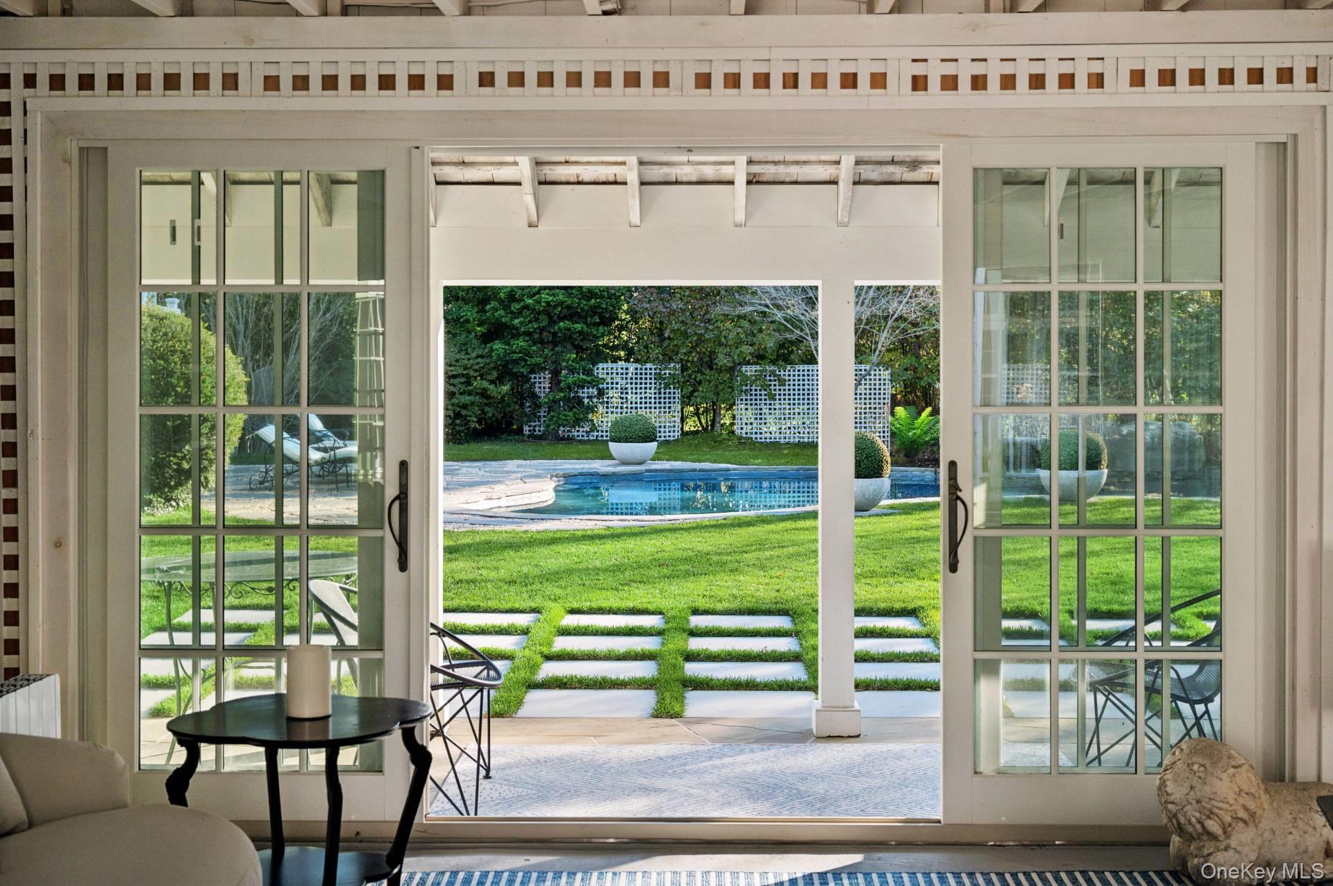 94 Post Lane Southampton, NY 11968 - Photo 31 of 34 a porch with a bench next to a yard