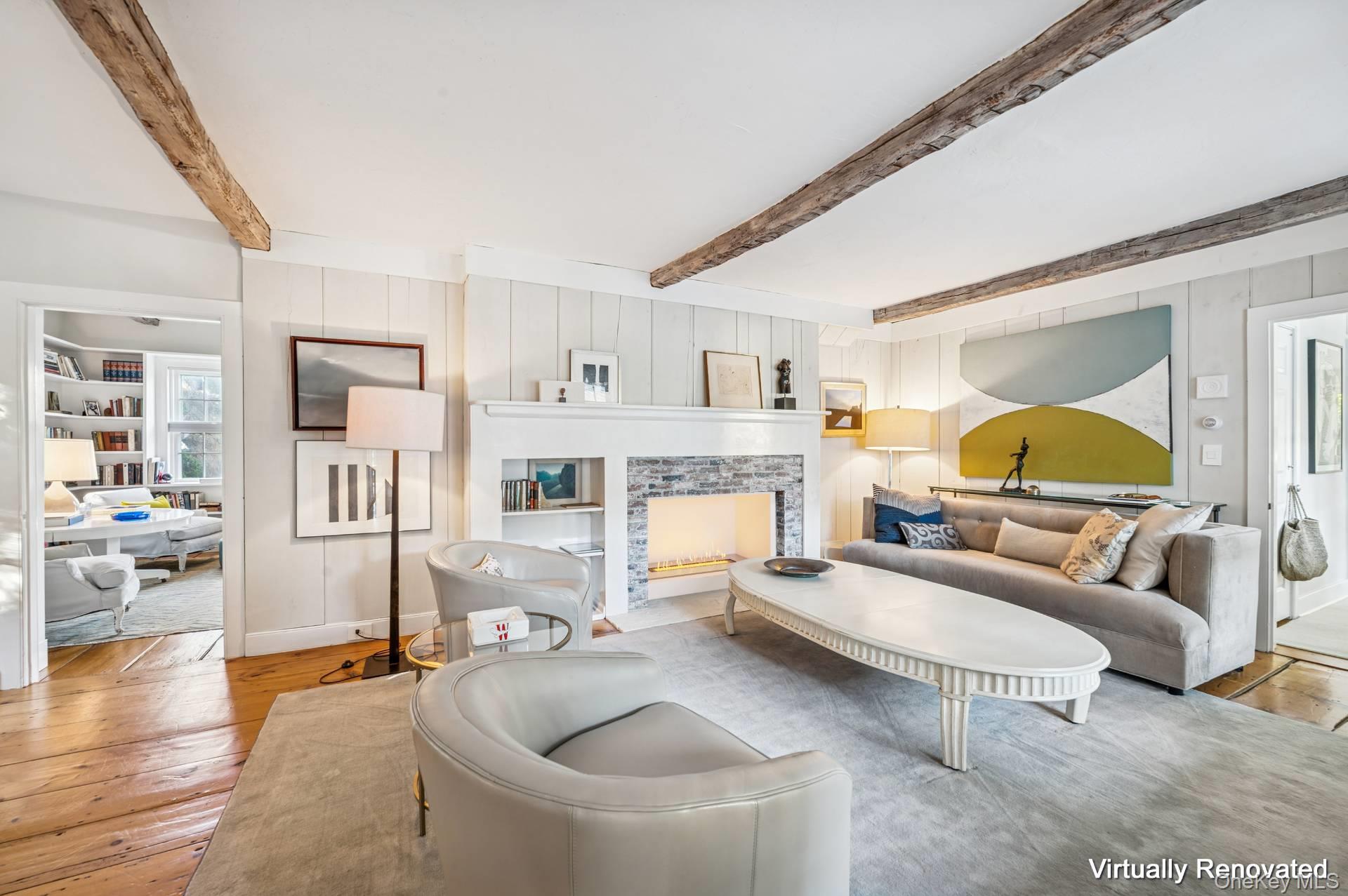 94 Post Lane Southampton, NY 11968 - Photo 9 of 34 a living room with furniture and a fireplace