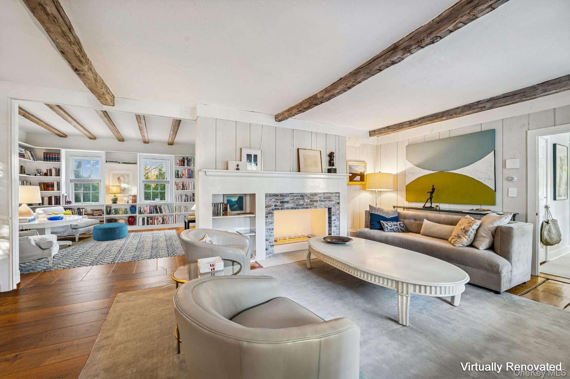 94 Post Lane Southampton, NY 11968 - Photo 10 of 34 a living room with furniture and a fireplace