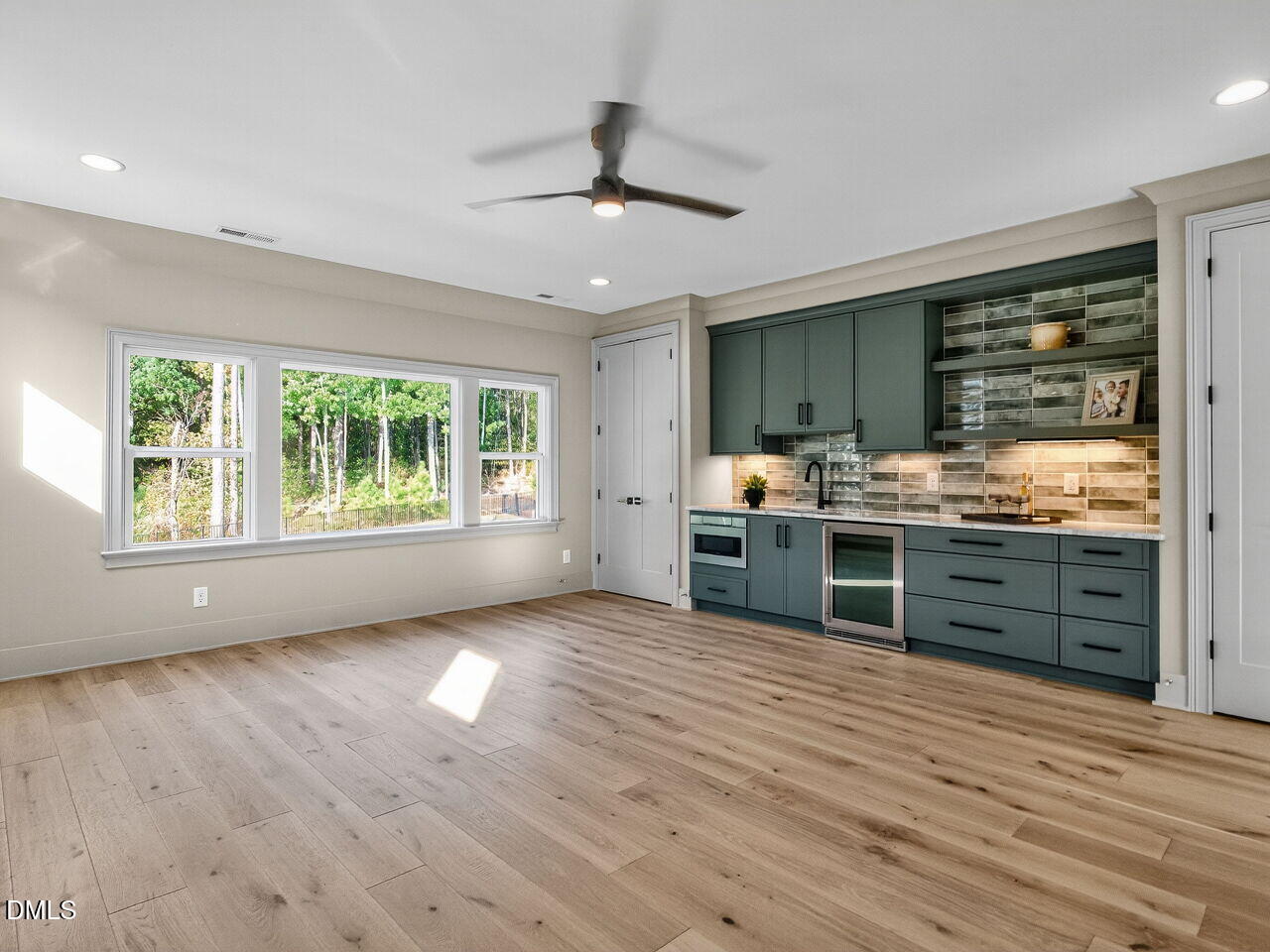 1309 Montvale Ridge Drive Cary, NC 27519 - Photo 18 of 24 a kitchen with stainless steel appliances wooden floors and view living room