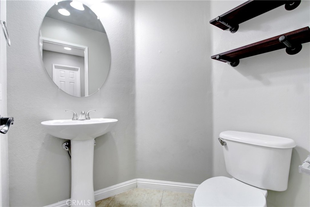 32509 Sunnyvail Circle Temecula, CA 92592 - Photo 12 of 38 a bathroom with a toilet a sink and a mirror