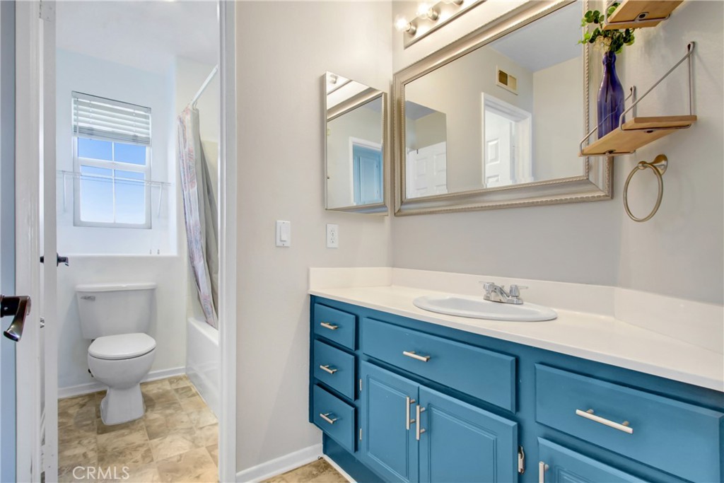 32509 Sunnyvail Circle Temecula, CA 92592 - Photo 17 of 38 a bathroom with a granite countertop sink a toilet and a mirror