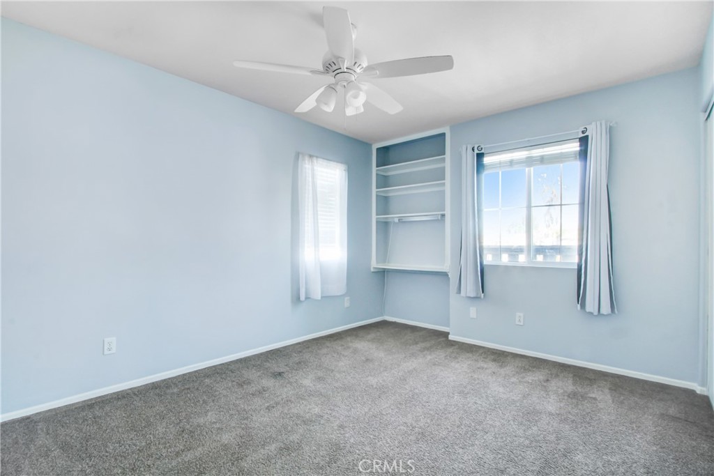 32509 Sunnyvail Circle Temecula, CA 92592 - Photo 19 of 38 an empty room with windows and chandelier fan