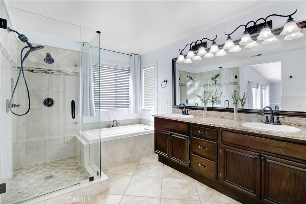 32509 Sunnyvail Circle Temecula, CA 92592 - Photo 26 of 38 a spacious bathroom with a granite countertop sink mirror and shower