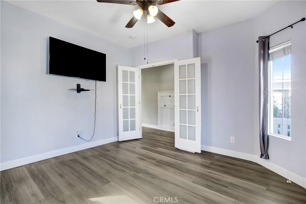 32509 Sunnyvail Circle Temecula, CA 92592 - Photo 5 of 38 an empty room with wooden floor cabinet and a flat screen tv