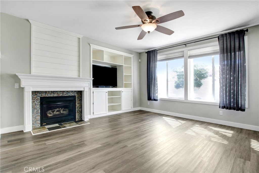 32509 Sunnyvail Circle Temecula, CA 92592 - Photo 7 of 38 a view of an empty room with wooden floor fireplace and a window