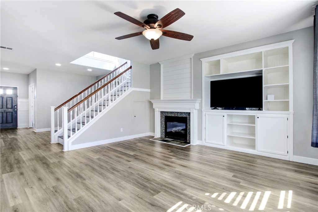 32509 Sunnyvail Circle Temecula, CA 92592 - Photo 8 of 38 a view of an empty room with wooden floor and a fireplace