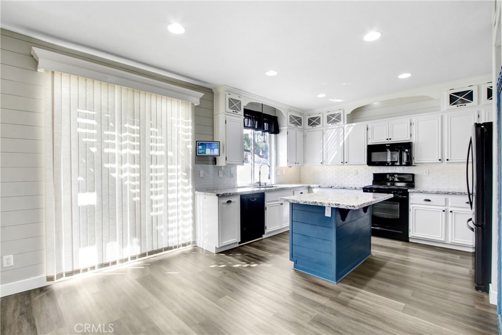 32509 Sunnyvail Circle Temecula, CA 92592 - Photo 10 of 38 a kitchen with stainless steel appliances granite countertop a refrigerator a sink dishwasher a stove and white countertops with wooden floor