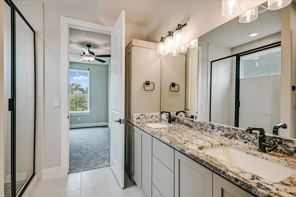 a bathroom with a granite countertop sink mirror and double