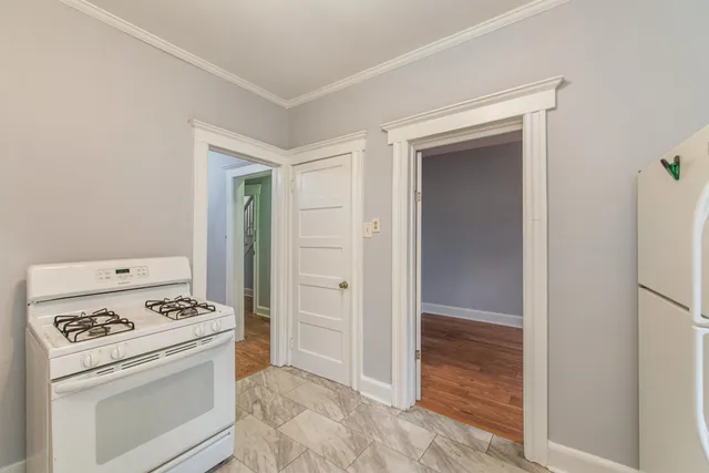a view of washer and dryer with kitchen in the background