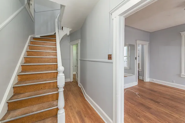 a view of entryway and hall with wooden floor