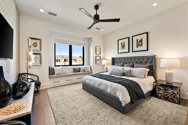 a bedroom with a bed a couch and a window