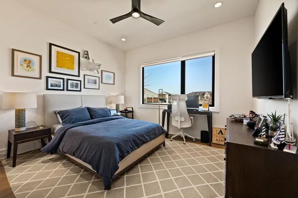 a bedroom with a bed and flat screen tv