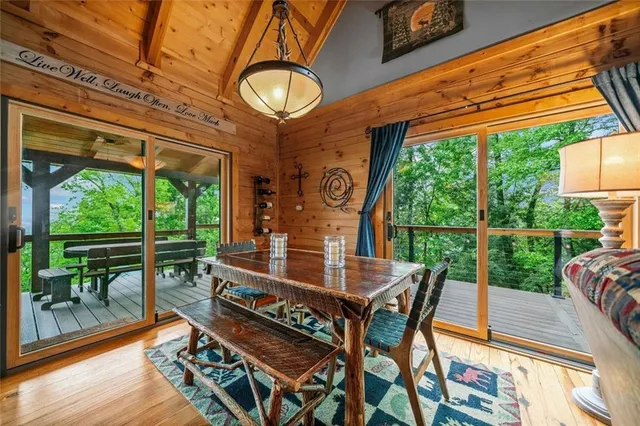 a view of a patio with a table chairs and a floor to ceiling window