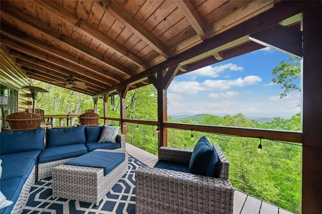 a balcony with furniture and a potted plant