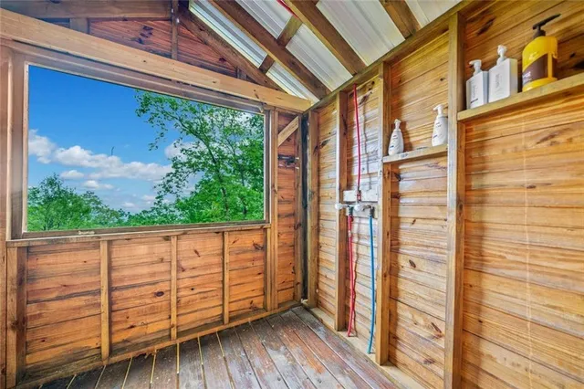 a view of a porch with wooden floor and iron stairs